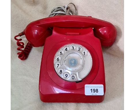 A vintage red telephone. 