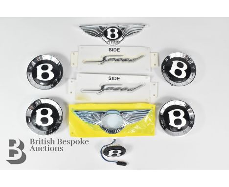 Bentley interest: including a set of four Bentley alloy wheel hub caps; a front nose cone, Bentley 'Wings' badge, a rear Bent
