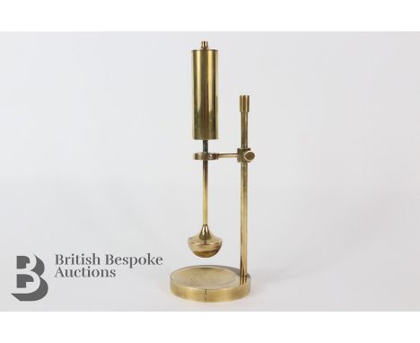 A Danish brass gyro oil lamp. The table lamp features an oil reservoir with a weighted pendulum base, with cotton cord wick. 