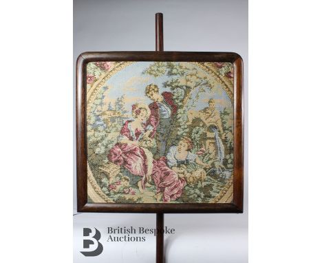A 19th Century face screen on a turned mahogany stand with tapestry depicting figures in a garden. Height of stand approx 130