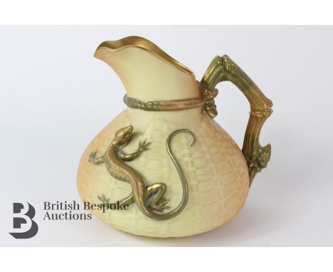 A Royal Worcester blush ivory basket weave ewer with a gilded lizard in relief, bamboo naturalistic handle, measuring approx 