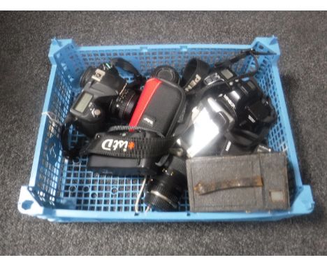 A basket containing assorted cameras including a Minolta Dynax 3000i, Pentax ISTD, digital cameras etc 