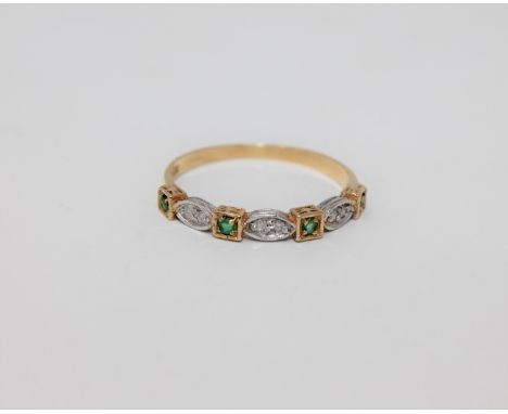 An 18ct gold emerald and diamond set half-eternity ring, size O