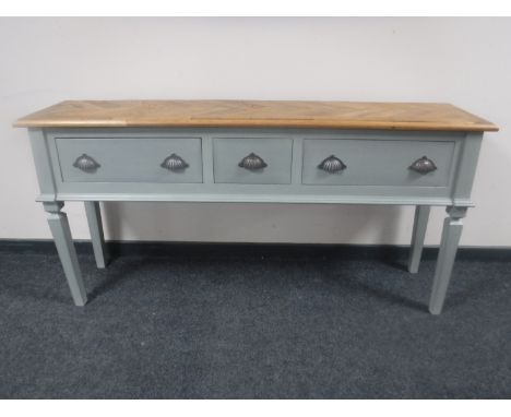 A painted three drawer console table with parquet panel top 