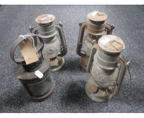 A vintage railway lamp and three Tilley lamps 