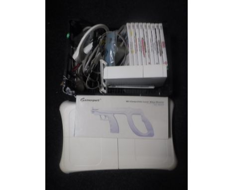 A Nintendo Wii games console with controller, leads, Wii fit board and games 