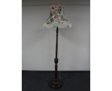 An early 20th century carved beech standard lamp with shade 
