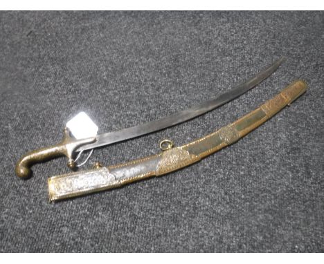 A 20th century eastern miniature Mamluk sword in embossed brass and leather scabbard CONDITION REPORT: 54cm overall. 