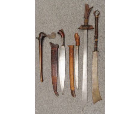 FOUR SOUTH EAST ASIAN EDGED WEAPONS AND A PACIFIC AXE, 19TH/EARLY 20TH CENTURY comprising a campilan, with hatchet-like blade