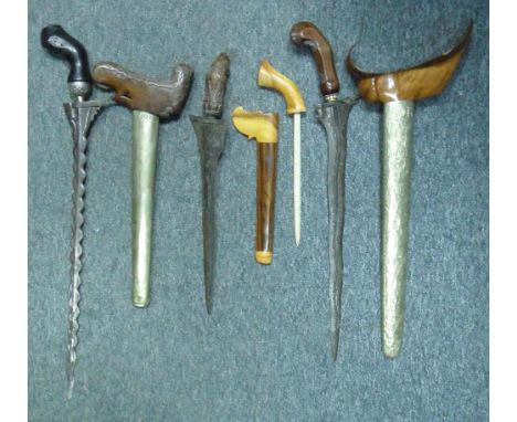 FOUR SOUTHEAST ASIAN EDGED WEAPONS, LATE 19TH/20TH CENTURY comprising a Javanese keris with wavy pattern-welded blade, paste-