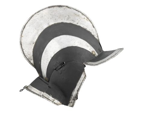 A GERMAN 'BLACK AND WHITE' BURGONET, EARLY 17TH CENTURY with rounded skull formed in two pieces joined along the crest of an 