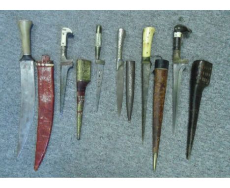 SIX MIDDLE EASTERN DAGGERS, 19TH CENTURY comprising an Afghan pesh-kabz with brass ferrule and bone grip-scales, in its leath