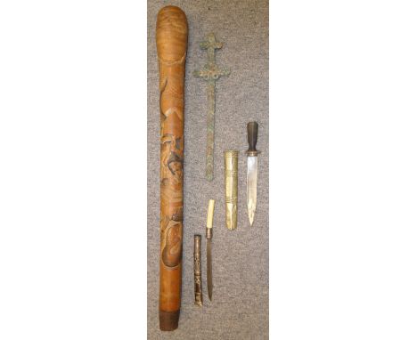 ##A BURMESE DHA DAGGER, A BHUTANESE DAGGER AN AFRICAN MONEY SWORD AND A JAPANESE CLUB, 19TH/20TH CENTURIES the first with sli