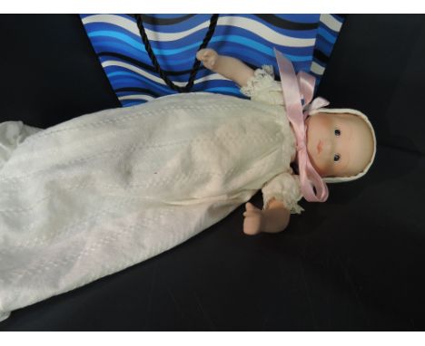 A modern bisque doll having cloth body