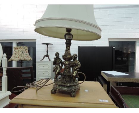 A modern resin figure group table lamp