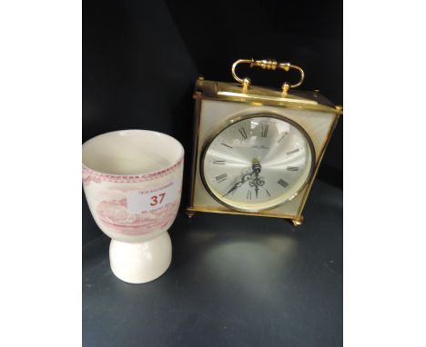A 19th Century design 'goose and hen' egg cup with rouge castle design and a 1970s style carriage clock