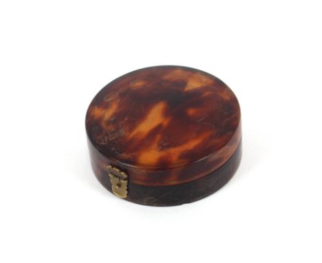A 19th Century tortoiseshell patch box, of circular form with mirror inset lid, 5cm dia.