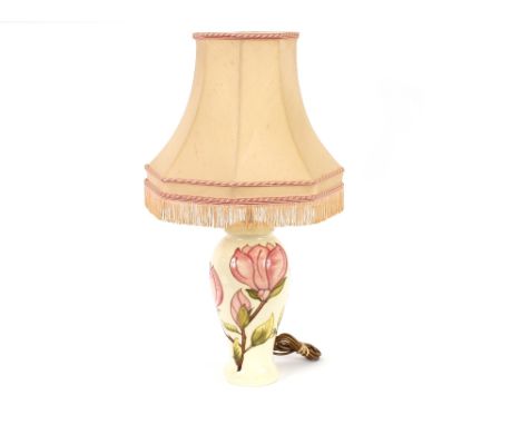 A Moorcroft pottery table lamp, Magnolia pattern, complete with shade