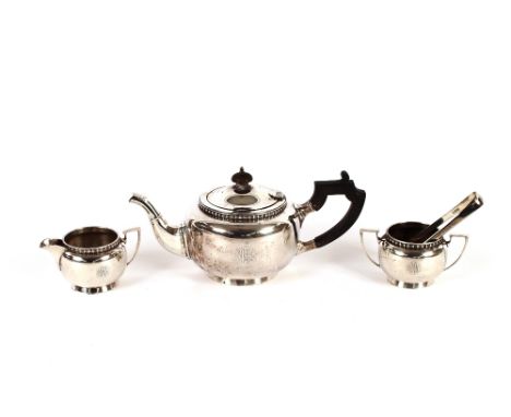 A three piece Indian white metal tea set, with stylised decoration, the teapot having wooden handle and lift; and a pair of G