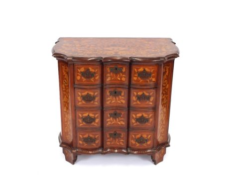 An 18th Century Dutch marquetry commode, of serpentine shape, profusely decorated with trailing foliage, fitted four drawers 