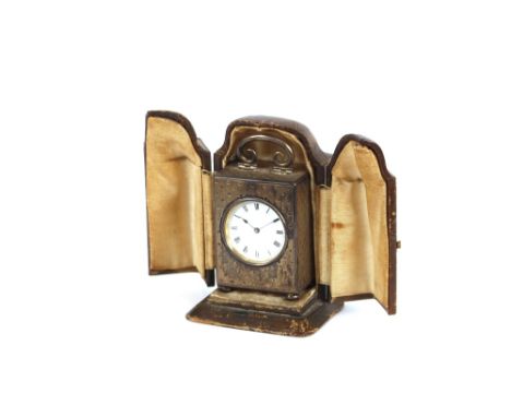 A miniature silver gilt carriage clock, contained in a leather folding travelling case
