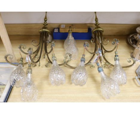 A pair of gilt brass three-light wall brackets, with scrolled arms, each hung with three engraved glass flower-shaped shades