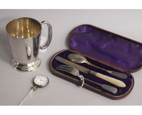 A silver Christening set, comprising knife, fork and spoon, a plated mug and a silver open face pocket watch, the Christening