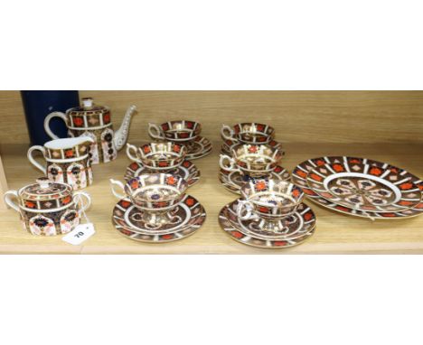 A Royal Crown Derby tea service, pattern no. 1128, comprising: teapot, sugar bowl and cover, milk jug, six cups, six saucers,