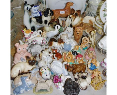 A Royal Doulton golden Spaniel on plinth base; other models of cats, dogs, horses etc including Nao, Beswick, Coopercraft and