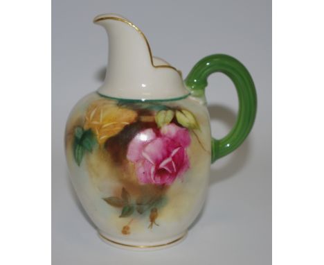 A Royal Worcester flat sided jug, decorated in the manner of Hadley with yellow and pink cabbage roses, reeded green loop han