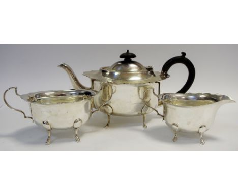 A silver three piece tea service comprising teapot, milk jug &amp; sugar bowl, wavy edged, cabriole legs, H.G.C. &amp; Co, Bi