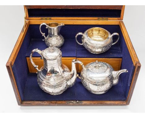 A Victorian Aesthetic silver four piece tea service including tea pot, coffee pot, sugar bowl and milk jug, all with profusel