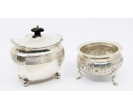 A late Victorian silver sucriere and cover, the bombe shaped body with reeded upper section on four ball feet, the slightly d