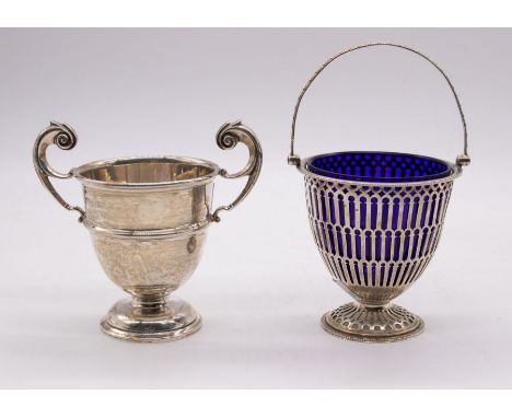 A George V silver Neo-Classical style pierced ovoid sugar basket, swing handle, on circular foot, blue glass liner, hallmarke