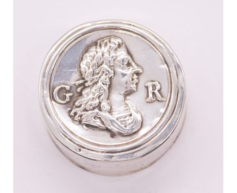 A George I silver circular patch box and cover, the cover embossed with a profile portrait of George I and GR., the base stam