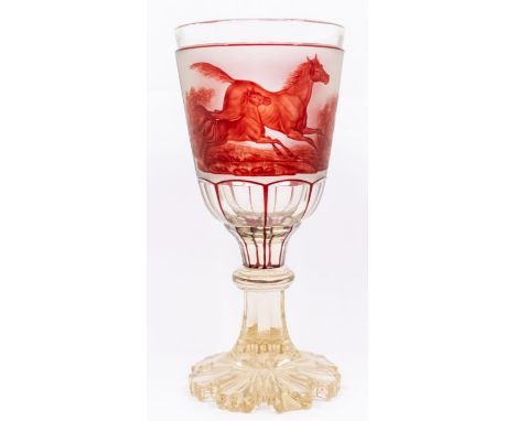 A mid 19th Century large Bohemian ruby and clear glass goblet, the front panel decorated with a cantering mare and foal in fe