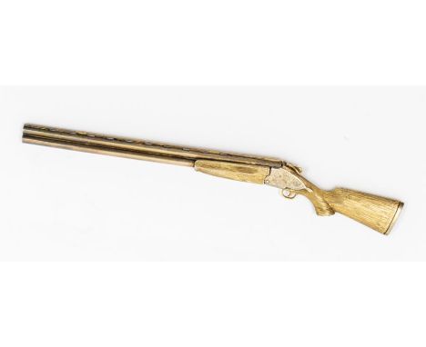 A Modern silver gilt model of a shotgun, hallmarked by T.J., Birmingham, 1987, in fitted case with gilt lettering Precious Me