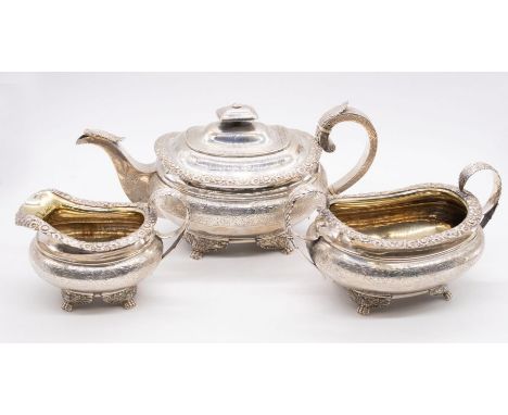 A matched Scottish George IV three piece tea service comprising teapot, sugar bowl and milk jug, boat shaped engraved with fl