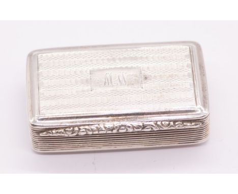 A William IV silver snuff box, engine turned with Regency stripes, reeded sides, ornate foliate thumbpiece, the cover engrave