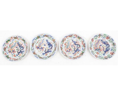 A set of four Chinese Ming Dynasty wucai porcelain dragon and phoenix small dishes, each with six character marks in blue of 