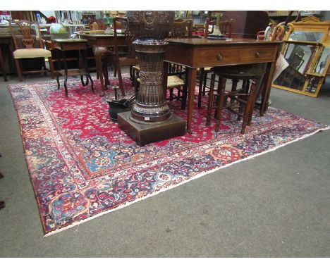 A large wool carpet in blues and reds, 350cm x 264cm  