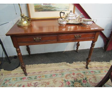 An Edwardian mahogany two-drawer side table on ring-turned legs