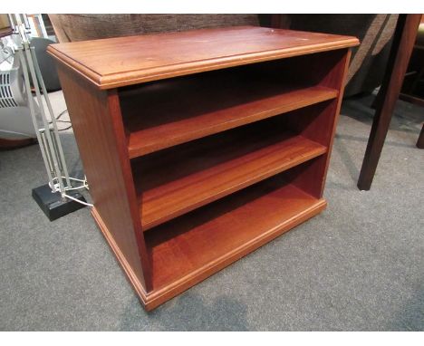 A modern mahogany three-tier entertainments shelf unit