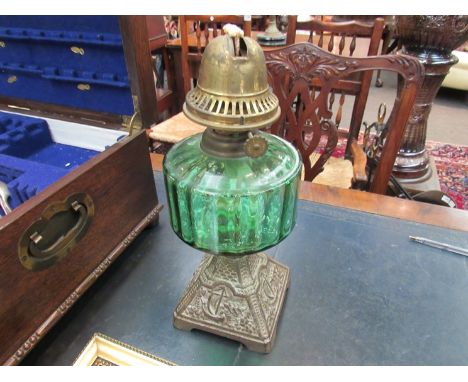 A green glass reservoir oil lamp, no shade