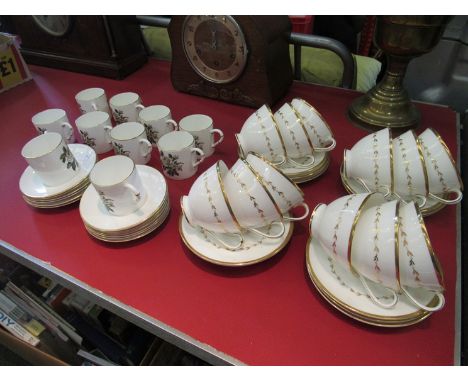 Twelve Royal Doulton "Covington" cups and saucers and ten Royal Worcester "White Rose" cups and saucers