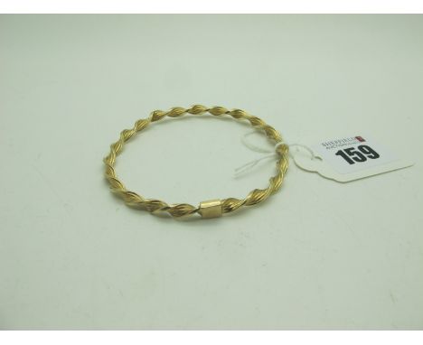 A Modern Bangle, of twisted design, stamped "375" (5grams). 