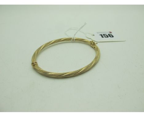 A Decorative Hinged Bangle, allover textured finish (sprung hinge) stamped "375" (4grams). 