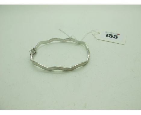 A Modern Hinged Bangle, of wavy design, stamped "375" (7.5grams). 