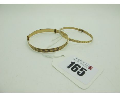 A 9ct Gold Child's Expanding Bangle, together with a smaller expanding bangle. (2) 