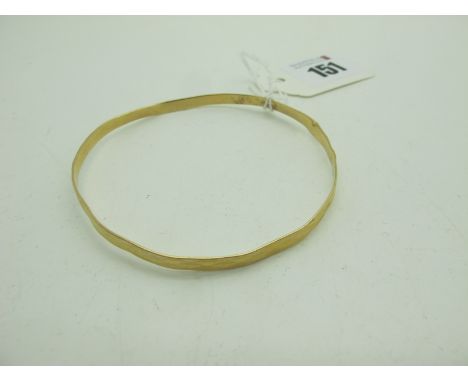 A Modern Bangle, with faceted decoration, stamped "750" (9.5grams) (misshapen). 